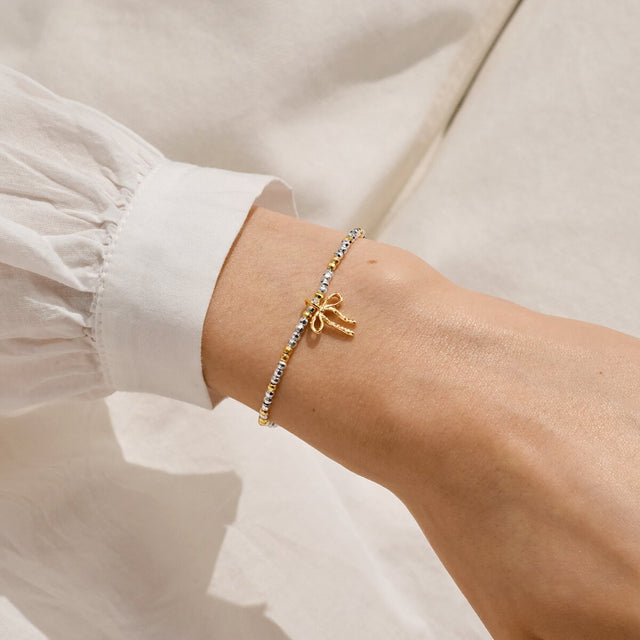 Joma Jewellery Fa La La La La silver and gold-plated bracelet worn on a wrist