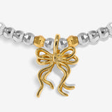 Joma Jewellery Happy Friendmas silver and gold-plated bracelet close-up of the gold-plated ribbon bow charm
