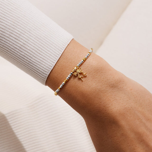 Joma Jewellery Happy Friendmas silver and gold-plated bracelet worn on a wrist