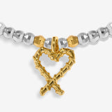 Joma Jewellery Naughty And Nice silver and gold-plated bracelet close-up of the gold-plated candy cane heart charm