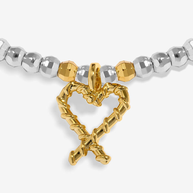 Joma Jewellery Naughty And Nice silver and gold-plated bracelet close-up of the gold-plated candy cane heart charm