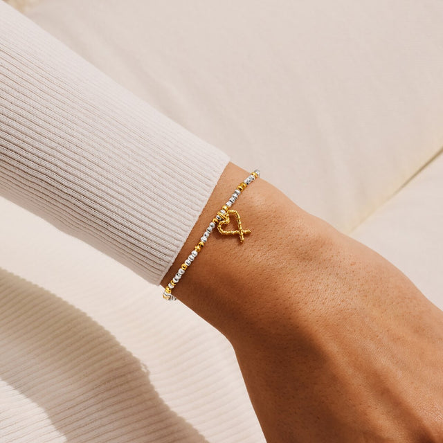 Joma Jewellery Naughty And Nice silver and gold-plated bracelet worn on a wrist