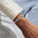 Silver beaded bracelet with gold star charms worn on wrist congratulations gift