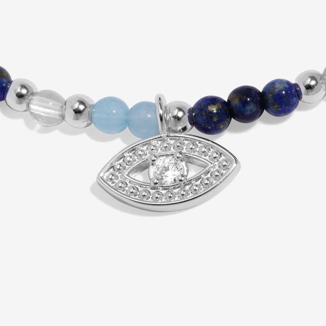 Close-up of evil eye charm on silver anklet