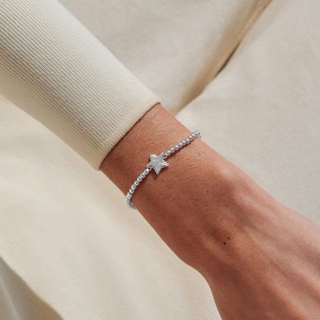 Joma Jewellery A Little exam results silver bracelet worn on wrist