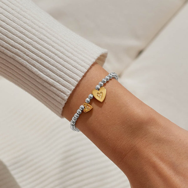 Silver and gold heart charm bracelet for mums worn on wrist