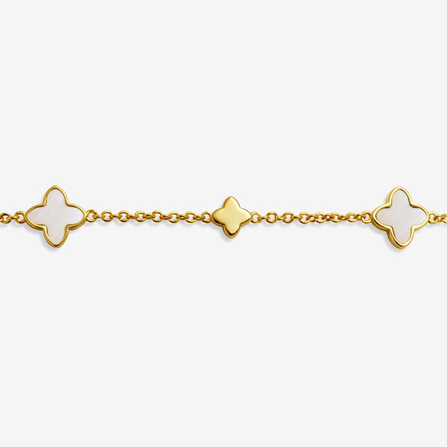 Mother of pearl clover charm detail on gold clover bracelet