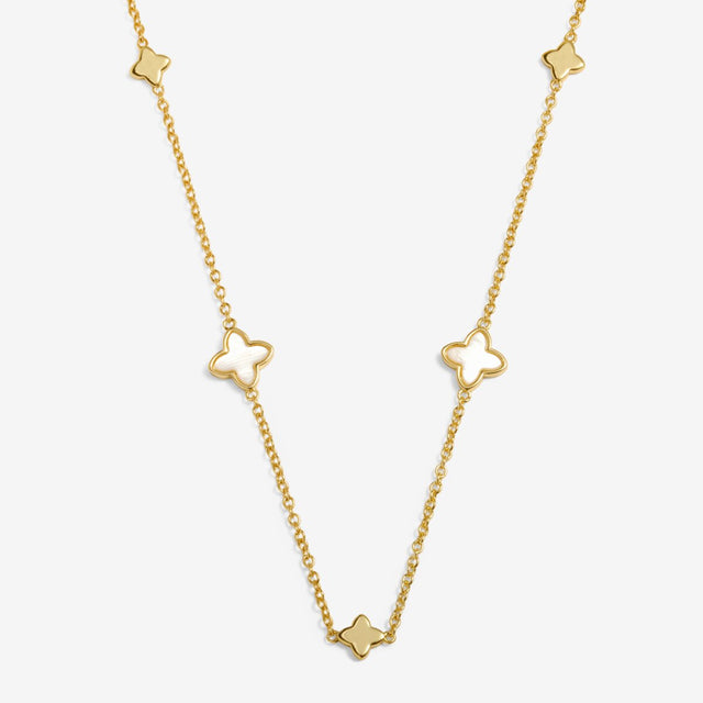 Gold clover necklace laid flat showing charm placement