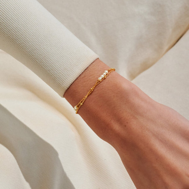 Gold pearl bracelet worn on wrist