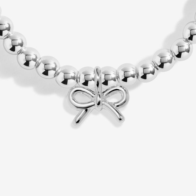 Silver bow charm detail on Joma Jewellery birthday bracelet
