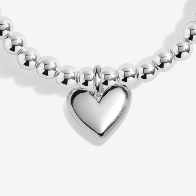 Close-up of silver heart charm on Happy Birthday bracelet