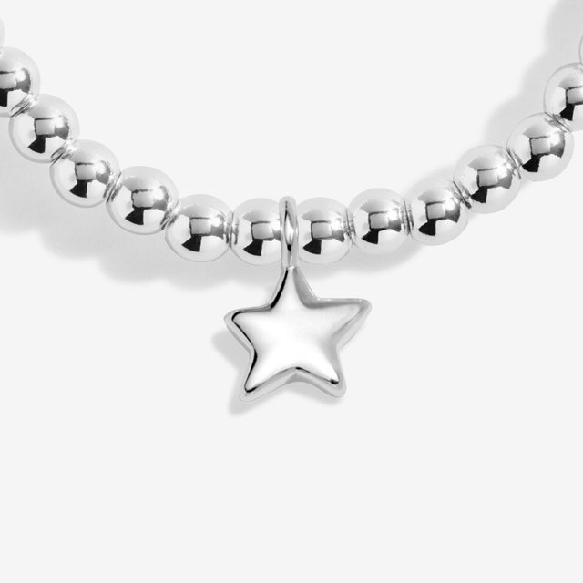 Close-up of silver star charm on Life’s A Charm bracelet