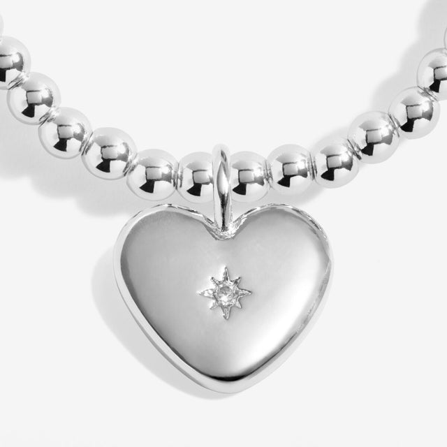Close up of heart charm on silver remembrance bracelet
