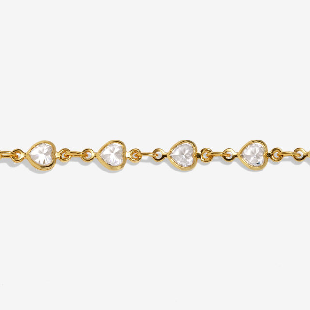 Close-up of Joma Jewellery gold heart tennis bracelet with crystal heart detailing