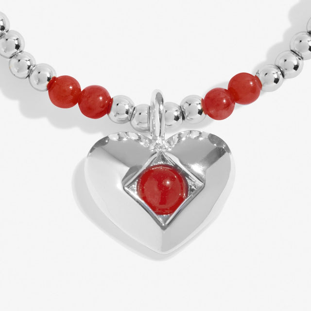 Close-up of garnet heart charm on Joma Jewellery January birthstone bracelet