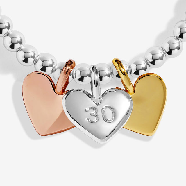 Silver, gold and rose gold heart charms on Joma Jewellery 30th birthday bracelet