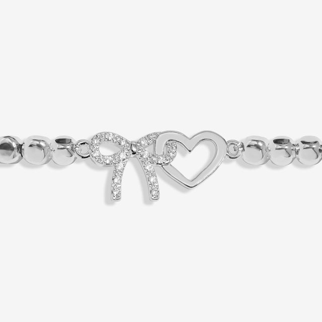 Interlinked silver bow and heart charms on Joma Jewellery Forever Yours Thank You bracelet