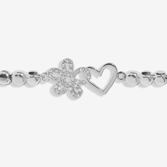 Interlinked silver flower and heart charms on Joma Jewellery sympathy bracelet