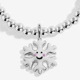Close-up of the smiling snowflake character charm on Joma Jewellery's Jomees Let It Snow kids' bracelet