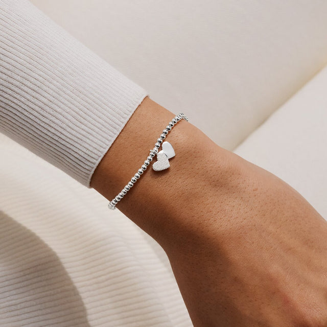 Joma Jewellery Merry Christmas Fabulous Friend silver-plated bracelet with double heart charm worn on a wrist
