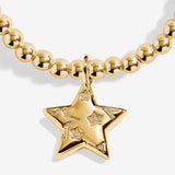 Close-up of the layered star charm on Joma Jewellery's Merry Christmas gold-plated bracelet