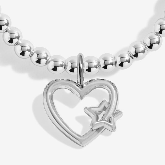 Close-up of the open heart and star charm on Joma Jewellery's Merry Christmas kids' bracelet