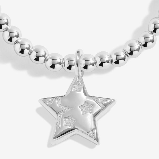 Close-up of the layered star charm on Joma Jewellery's Merry Christmas silver-plated bracelet