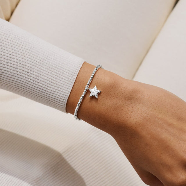 Joma Jewellery Merry Christmas silver-plated bracelet with layered star charm worn on a wrist