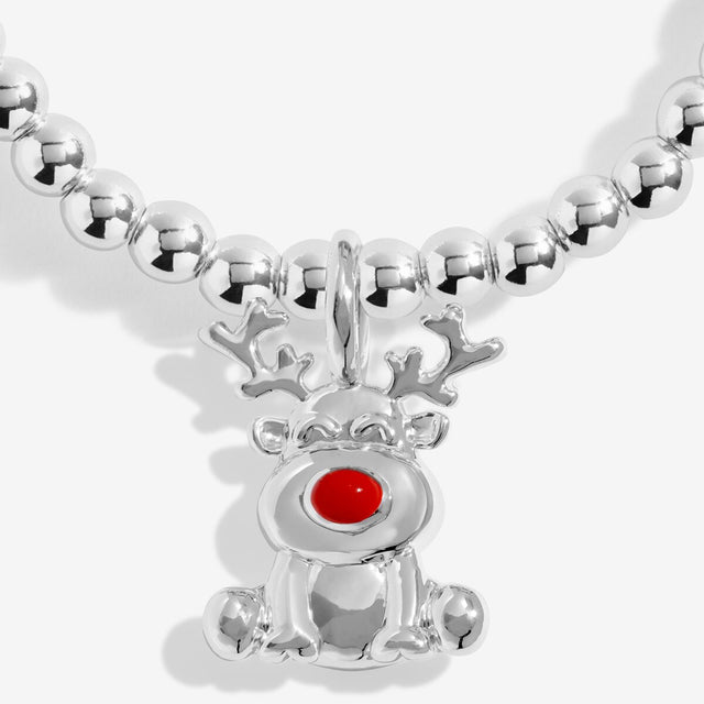 Close-up of the reindeer charm with a bright red nose on Joma Jewellery's Rudolph The Red Nosed Reindeer kids' bracelet
