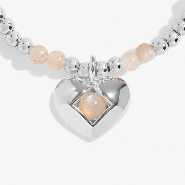 Close-up of sunstone birthstone heart charm on Joma Jewellery bracelet