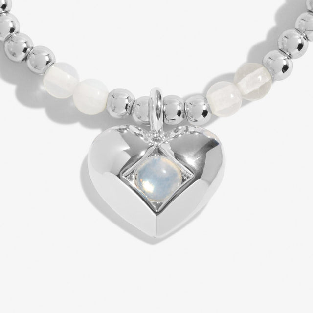 Close-up of moonstone birthstone heart charm on Joma Jewellery bracelet