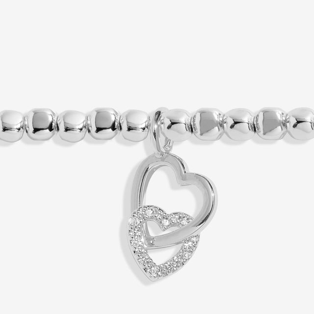 Close up of interlinked heart charms on silver auntie bracelet