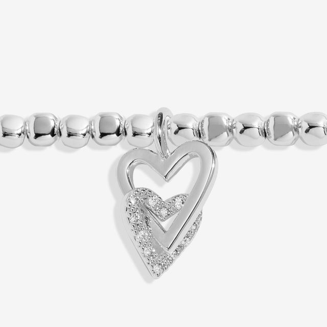 Close up of interlinked heart charms on silver grandma bracelet