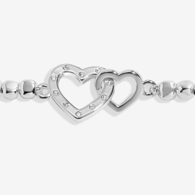 Close up of interlinked heart charms on grandma bracelet
