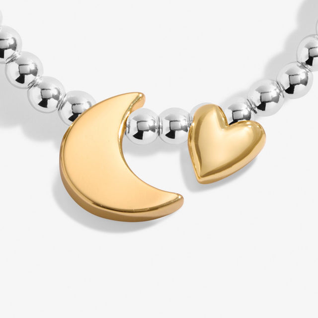 Close up of gold moon and heart charms on Joma silver beaded bracelet