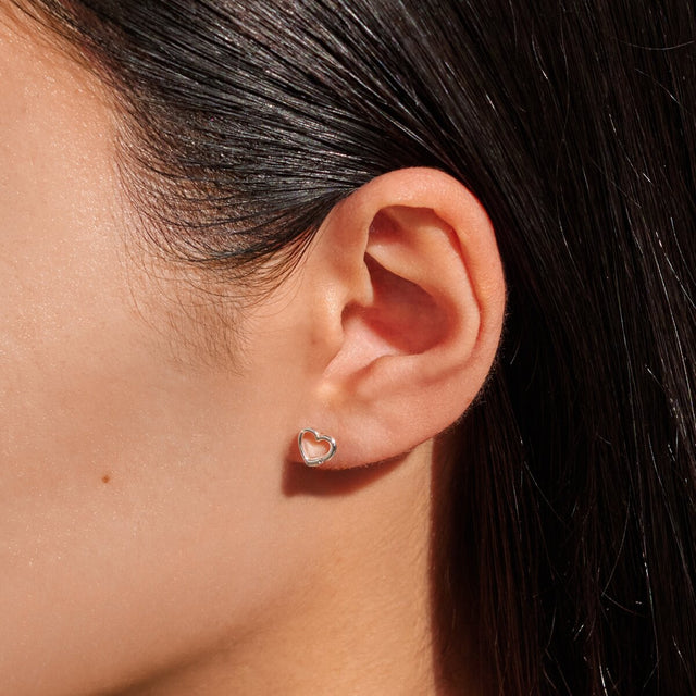 Silver heart stud earrings present for daughter worn on ear