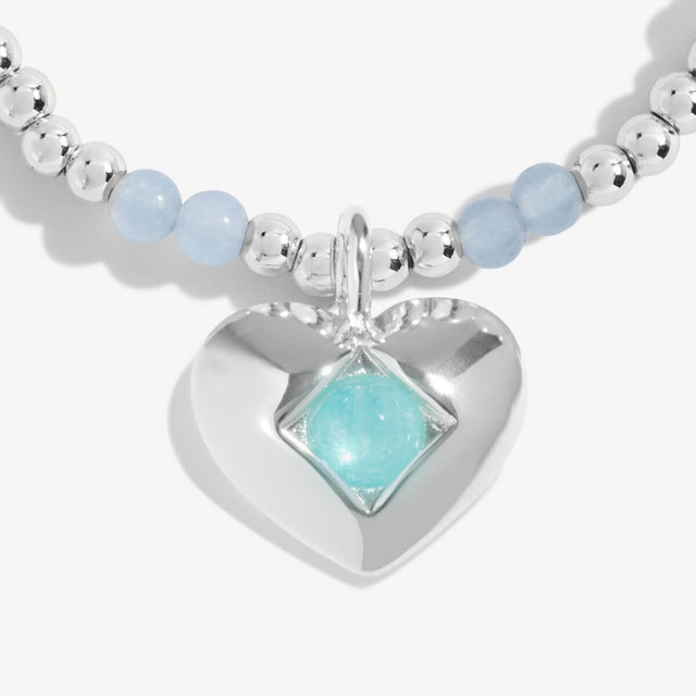 Close-up of aqua crystal birthstone heart charm on Joma Jewellery bracelet