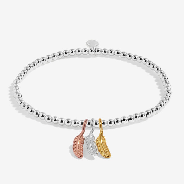Silver beaded stretch bracelet with silver, gold and rose gold feather charms