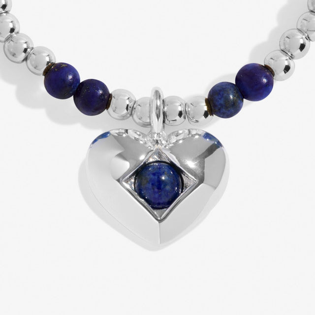 Close-up of lapis lazuli birthstone heart charm on Joma Jewellery bracelet