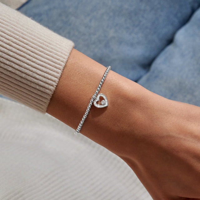 Joma silver thank you heart bracelet worn on wrist
