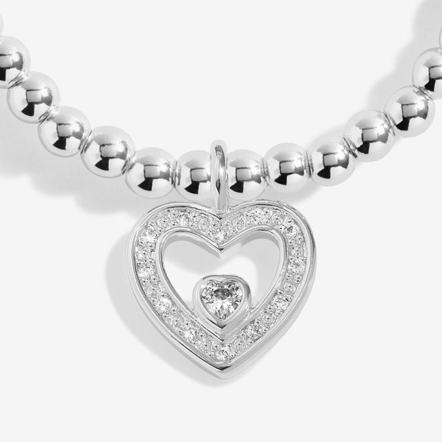 Close-up of silver heart charm on Joma thank you bracelet