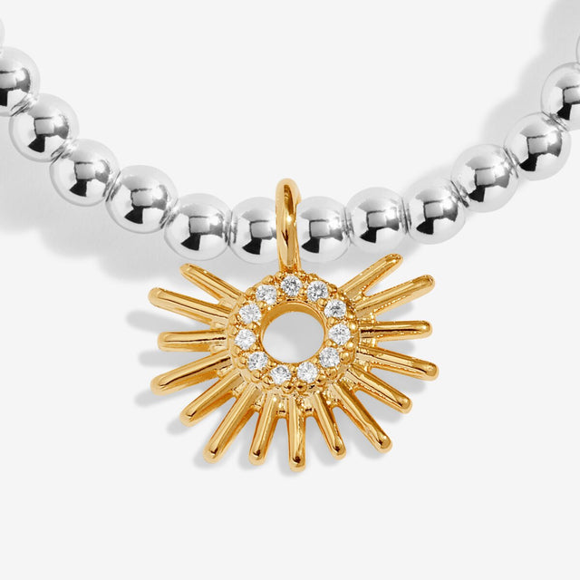 Close-up of gold sunburst charm on Joma You Brighten My Day bracelet