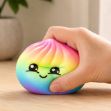 Kawaii Rainbow Bao Bun Squishy Fidget Toy being squeezed in hand for stress relief, anxiety reduction and sensory play