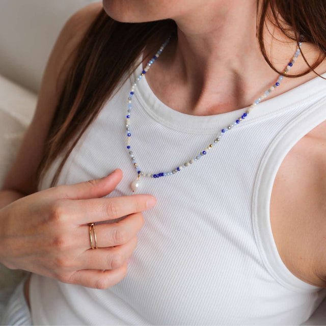 Azure Drift crystal jewellery wrap worn as layered necklace.