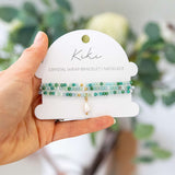 Kiki Emerald Song crystal jewellery wrap on display card packaging.