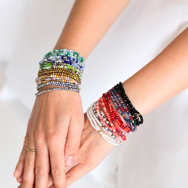 Green Oracle crystal jewellery wrap worn as layered bracelet.