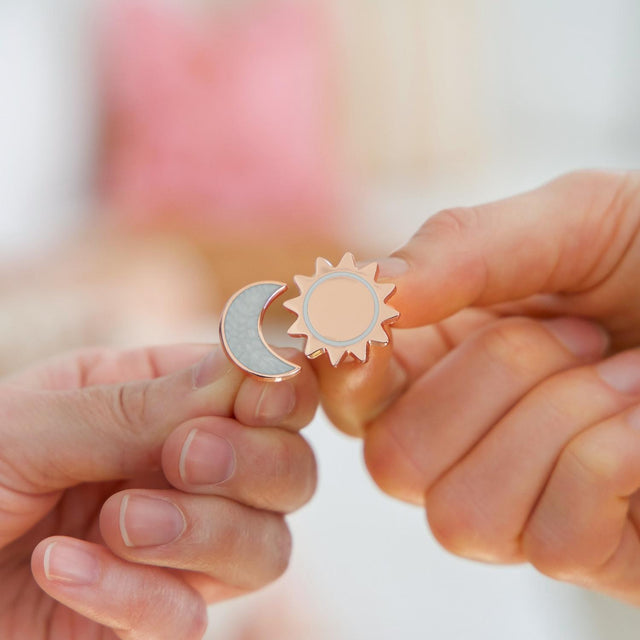 Mother and daughter exchanging the Splosh Forever Connected keepsake pins.