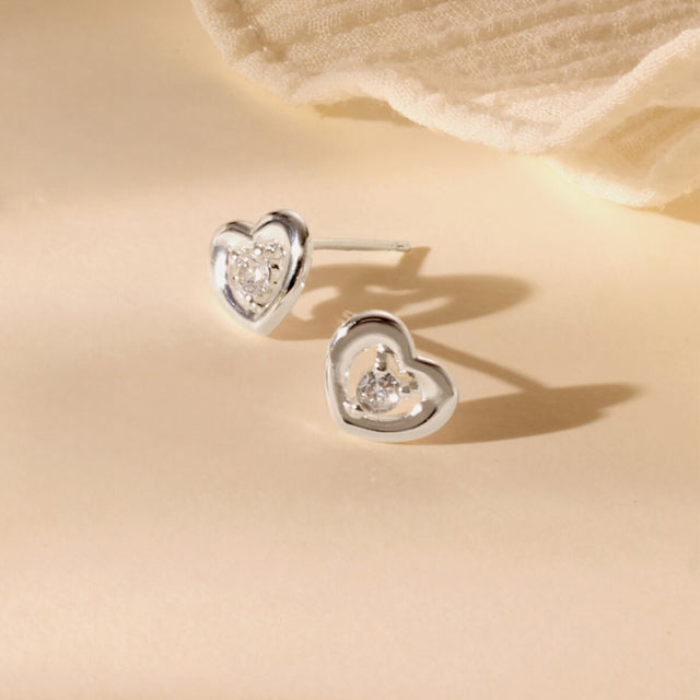 Silver heart mum jewellery earrings styled on neutral background