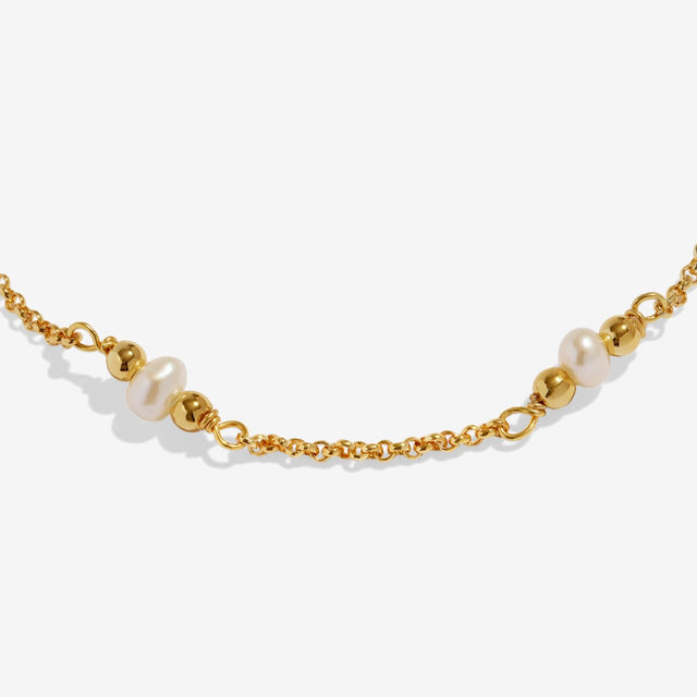 Close-up of pearl details on fine chain gold anklet
