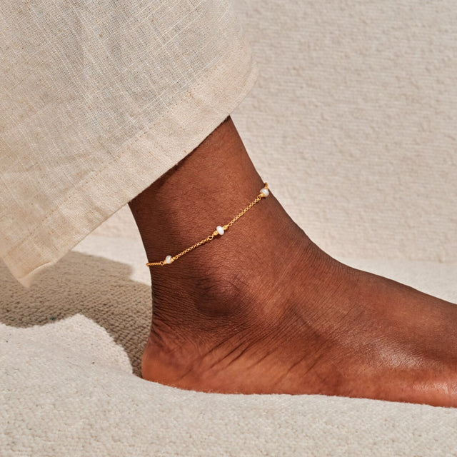 Delicate pearl gold anklet worn on ankle